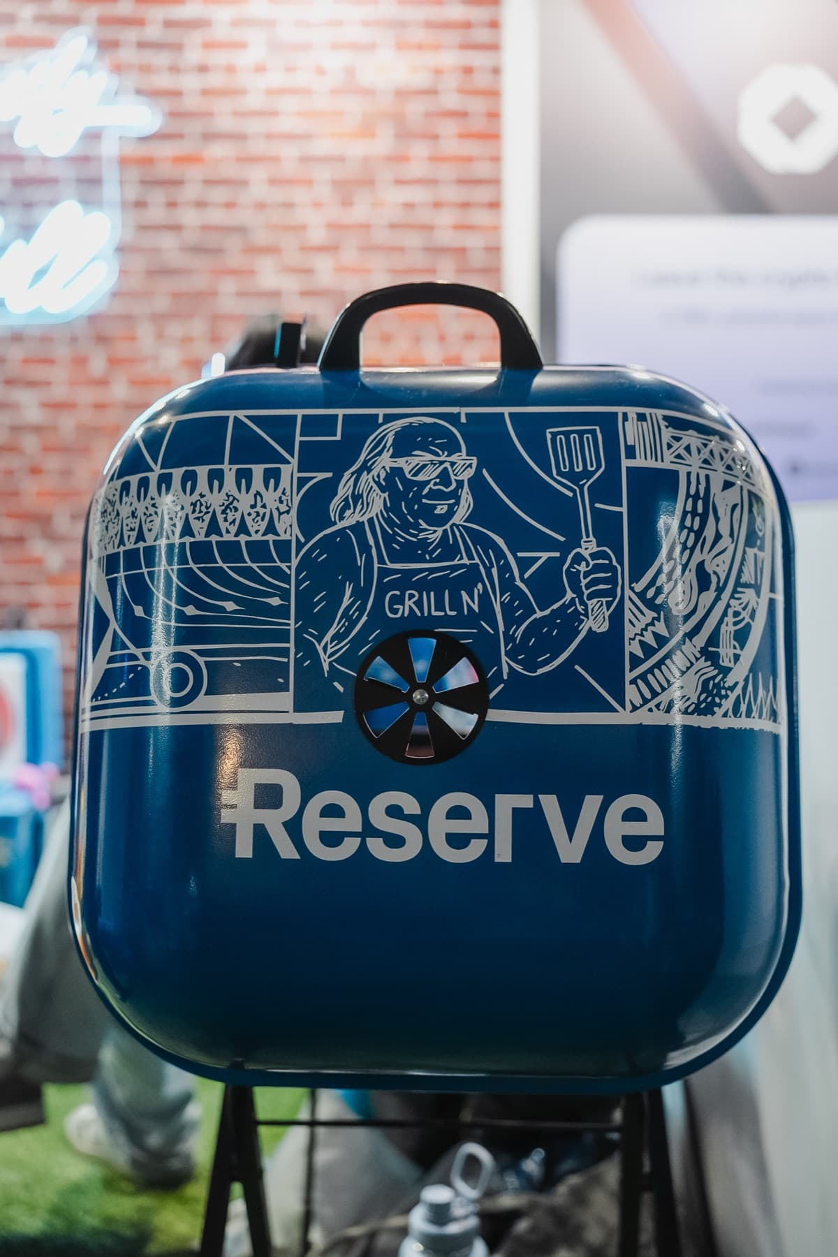 A blue grill with custom Reserve artwork